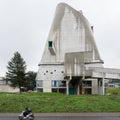 Facade of the Saint-Pierre Catholic church construction in Firminy, France under light sky Royalty Free Stock Photo