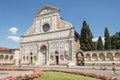 Facade of Santa Maria Novella Church Florence, Italy with tourists walking nearby