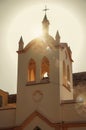 Facade of small church and belfry with sunshine behind at sunset in SÃÂ£o Manuel. Royalty Free Stock Photo