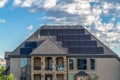 Facade of a solar powered home with spiral staircase going up to the balcony