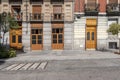 Facade of some vintage residential buildings in the center of the city of Madrid with wooden access doors to the interior