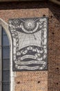 Facade of St. Mary\'s Church with sundial designed by Tadeusz Przypkowski, made with sgraffito technique, Krakow, Poland