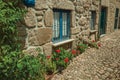 Facade of stone house with barred windows and flowers Royalty Free Stock Photo