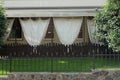 The facade of the summer veranda of the restaurant with brown curtains on the street