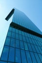 A facade of a tall modern corporate building consisting of rectangles of shaded glass Royalty Free Stock Photo