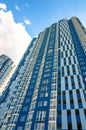 Facade of a tall residential building. High-rise buildings modern architecture skyline