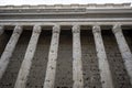 The facade of the Temple di Adriano in Rome, Italy. Perspective of ancient colonnade in the foreground Royalty Free Stock Photo