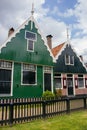 Facade of traditional dutch buildings in village. Old brick and wooden houses in Zaanse Schans, Netherlands. Royalty Free Stock Photo