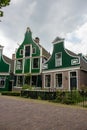 Facade of traditional dutch buildings in village. Old brick and wooden houses in Zaanse Schans, Netherlands. Royalty Free Stock Photo