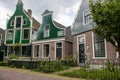 Facade of traditional dutch buildings in village. Old brick and wooden houses in Zaanse Schans, Netherlands. Royalty Free Stock Photo