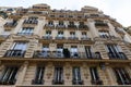 The facade of traditional French house with typical balconies and windows. Paris. Royalty Free Stock Photo