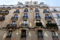 The facade of traditional French house with typical balconies and windows. Paris Royalty Free Stock Photo