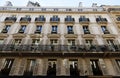 The facade of traditional French house with typical balconies and windows. Paris. Royalty Free Stock Photo