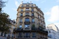 The facade of traditional French house with typical balconies and windows. Paris.