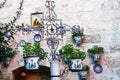 Facade of a traditional house with decorative ceramic plates and pots of flowers