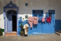 Facade of a traditional house with laundry hanging outdoors in the medina of Assilah