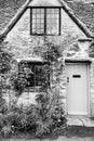 Facade of traditional small cottage home in Bibury village, Cotswolds, Egland, UK Royalty Free Stock Photo