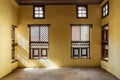 Facade of two Interleaved wooden ornate windows - Mashrabiya - in stone wall