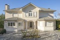 Facade of a two-story single-family residential house with slate roofs and a hall with a porch with cylindrical columns Royalty Free Stock Photo