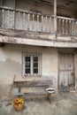 Facade of a typical house with a hoe, a basket full of apples, a bench and a basin with chestnuts, Gratila, Nava, Asturias, Spain