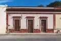 Facade of typical Mexican colonial building with wooden doors in Merida, Yucatan, Mexico