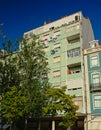 Facade of a typical pastel colored apartment building in Lisbon, Portugal