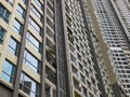 Facade of an upscale condominium in Ho Chi Minh City, Vietnam. Beige and brown painted smooth concrete, floor to ceiling windows