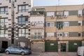 Facade of urban residential building at street level with garages,