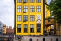 Facade view of a famous old yellow industrial building. Museum Arbetets Hus with incidental people in Norrkoping Sweden.