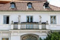 Facade vintage houses with balconies and statues