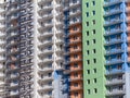 Facade of the wall of a new residential building. Half of the wall is white, half is painted