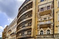 Facade of a weathering apartment building on the edge of downtown next to magnificently renovated buildings