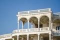 facade of the white building with arches and balconies against the background of blue sky Royalty Free Stock Photo