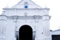 Facade of white Chapel of Calvary or Capilla del Calvario across the market square