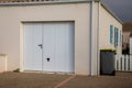 facade white house with close garage door of suburb home