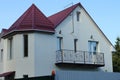 Facade of a white private house with an open black iron balcony Royalty Free Stock Photo