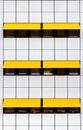 Facade with white tiles and yellow awnings