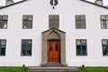 The facade of a white two-story building in Reykjavik, the capital of Iceland.