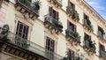 Facade with windows and balconies decorated with plants Royalty Free Stock Photo