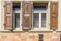 Facade with windows with stained glass and wooden shutters Royalty Free Stock Photo