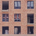 Facade with windows of an unfinished building, closeup house Royalty Free Stock Photo