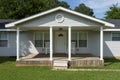 The facade of a wood house with a porch at a rural area of the State of Tennessee