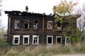 The facade of an wooden house damaged by a fire. The burnt section of the building.