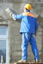 Facade worker plastering wall
