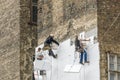 Facade workers mounting polystyrene insulation Royalty Free Stock Photo