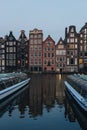 facades of ancient building above canal on twilight, Amsterdam, Netherlands