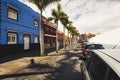 Facades of colourful houses and palm trees on typical canarian street, Puerto de La Cruz, Tenerife, Spain Royalty Free Stock Photo