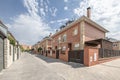 Facades of exposed brick buildings built with the typology of single-family houses on the outskirts