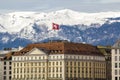 Facades of historic buildings in the city center of Geneva, Switzerland on the Leman lake with snow covered Alps mountains peaks Royalty Free Stock Photo