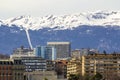 Facades of historic buildings in the city center of Geneva, Switzerland on the Leman lake with snow covered Alps mountains peaks Royalty Free Stock Photo